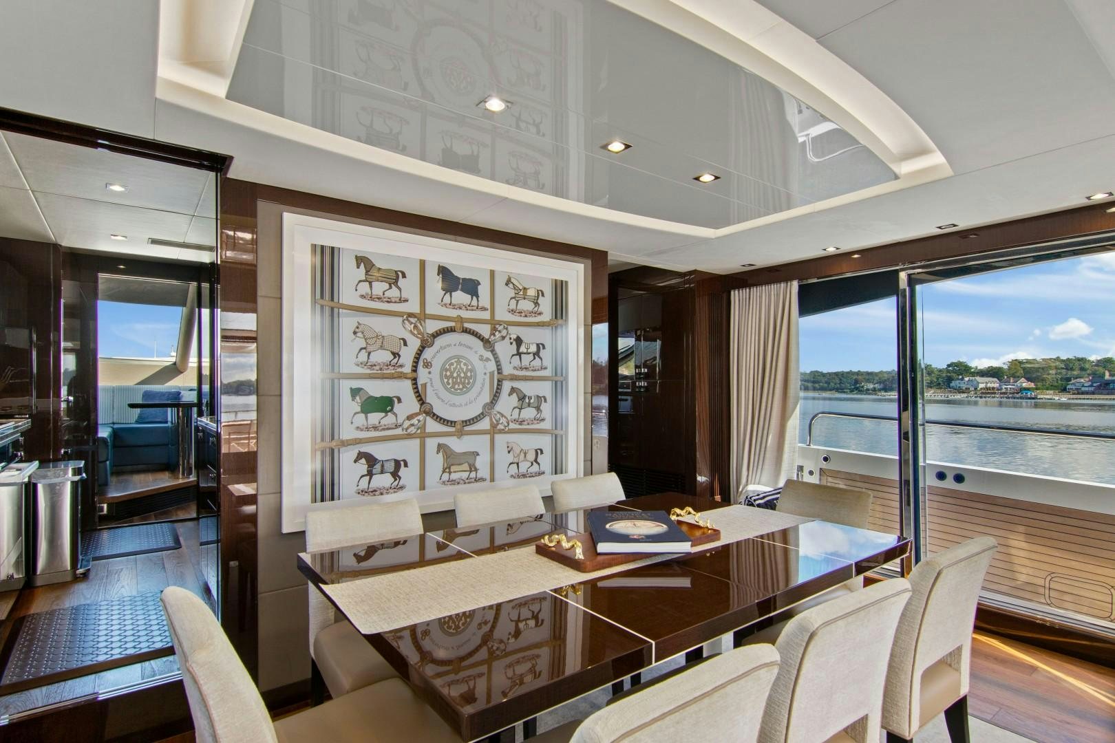 a room with a table chairs and a large window aboard GOLDEN OURS Yacht for Sale