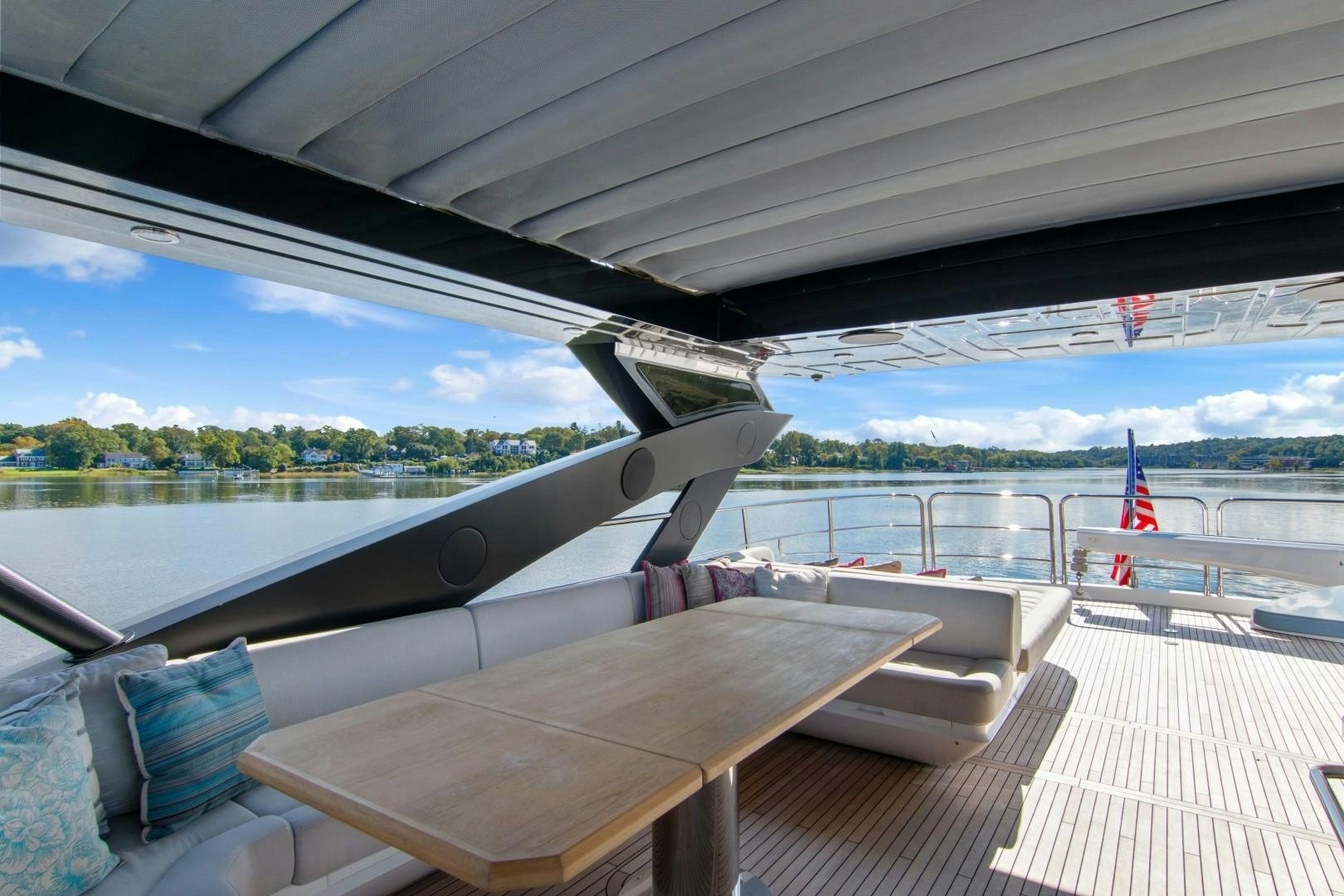 a deck with a view of a lake and a large building aboard GOLDEN OURS Yacht for Sale