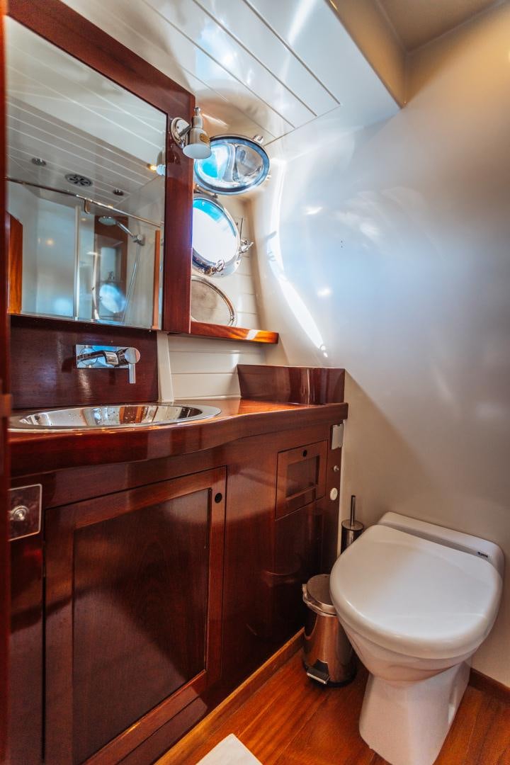a bathroom with a toilet and a sink aboard LARIMAR Yacht for Sale