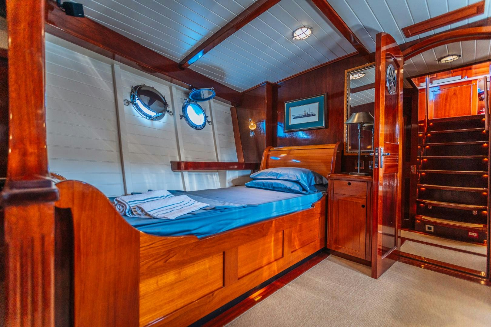 a room with a bed and a wood closet aboard LARIMAR Yacht for Sale