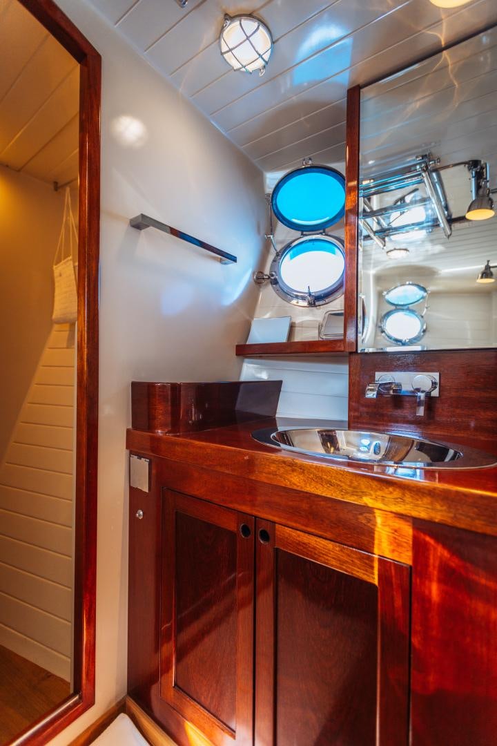 a bathroom with a sink and a mirror aboard LARIMAR Yacht for Sale