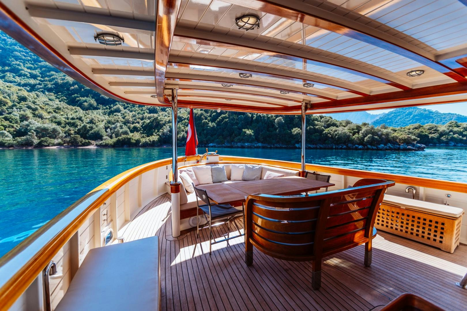 a deck with chairs and a table on it aboard LARIMAR Yacht for Sale