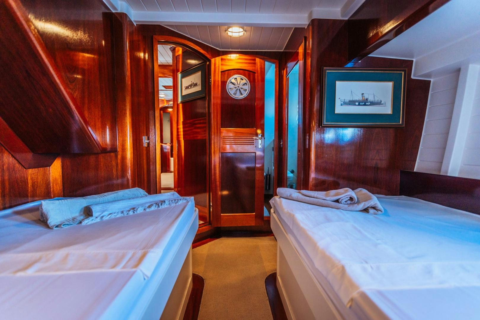 a room with beds and a clock aboard LARIMAR Yacht for Sale