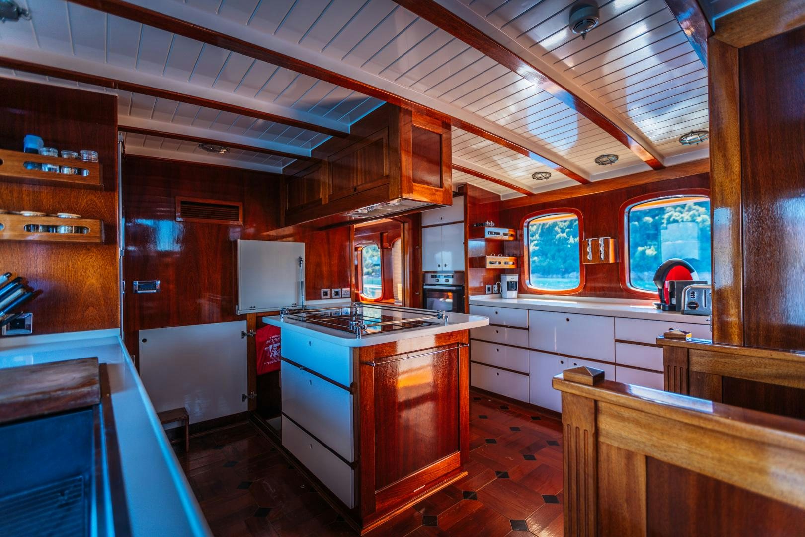 a kitchen with wooden cabinets aboard LARIMAR Yacht for Sale