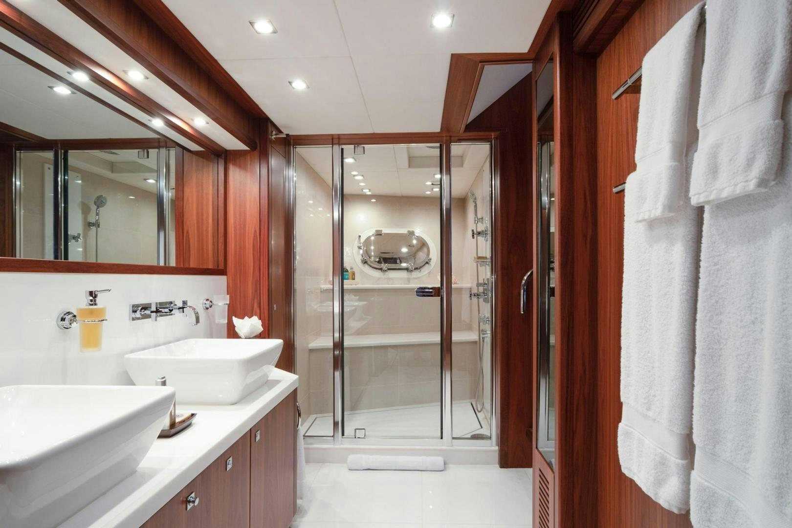 a bathroom with a glass shower aboard ACACIA Yacht for Sale