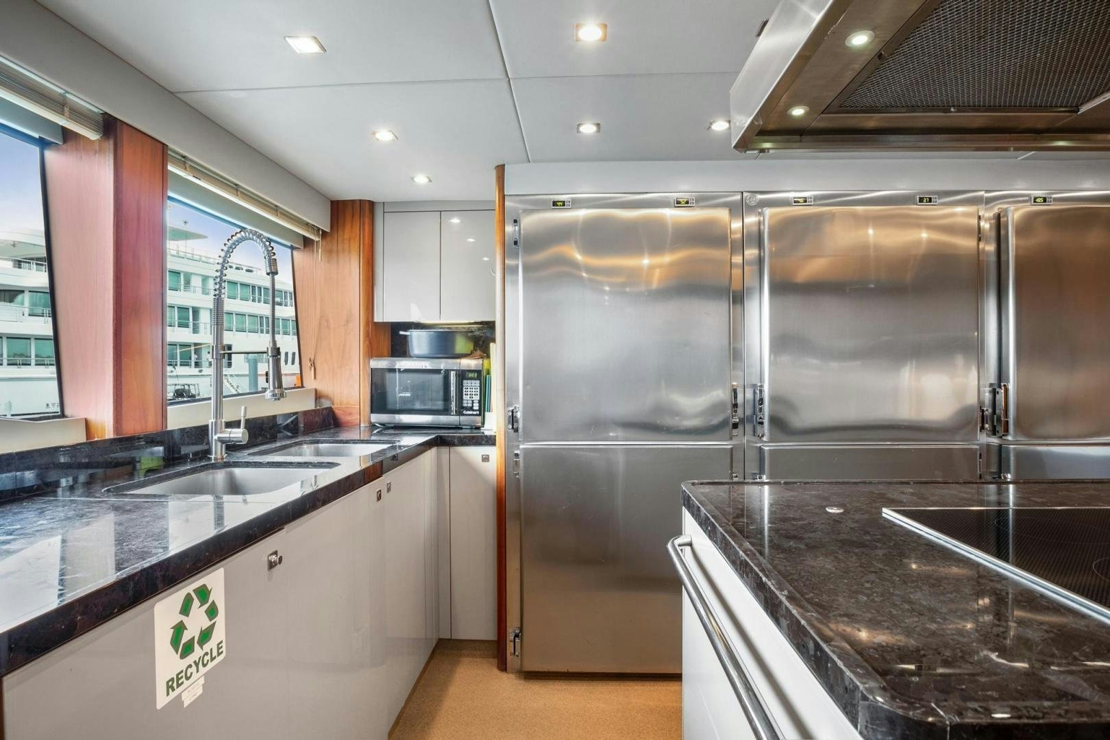 a kitchen with stainless steel appliances aboard ACACIA Yacht for Sale