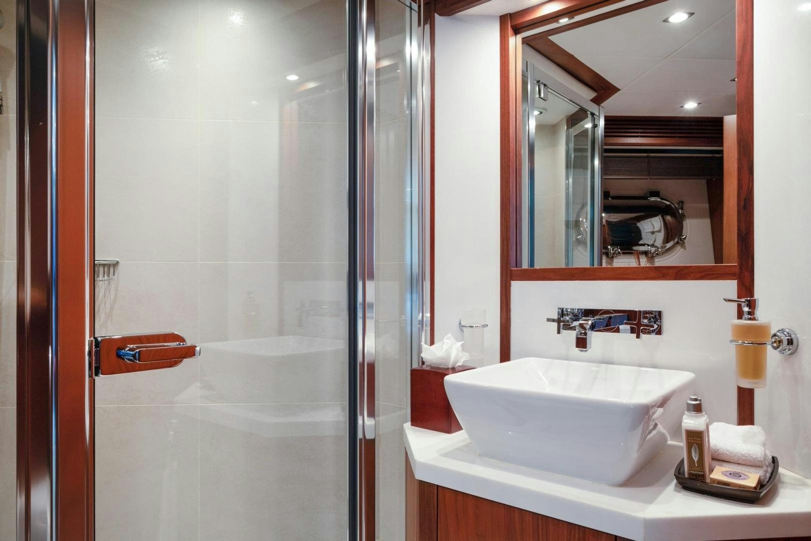 a bathroom with a large mirror aboard ACACIA Yacht for Sale
