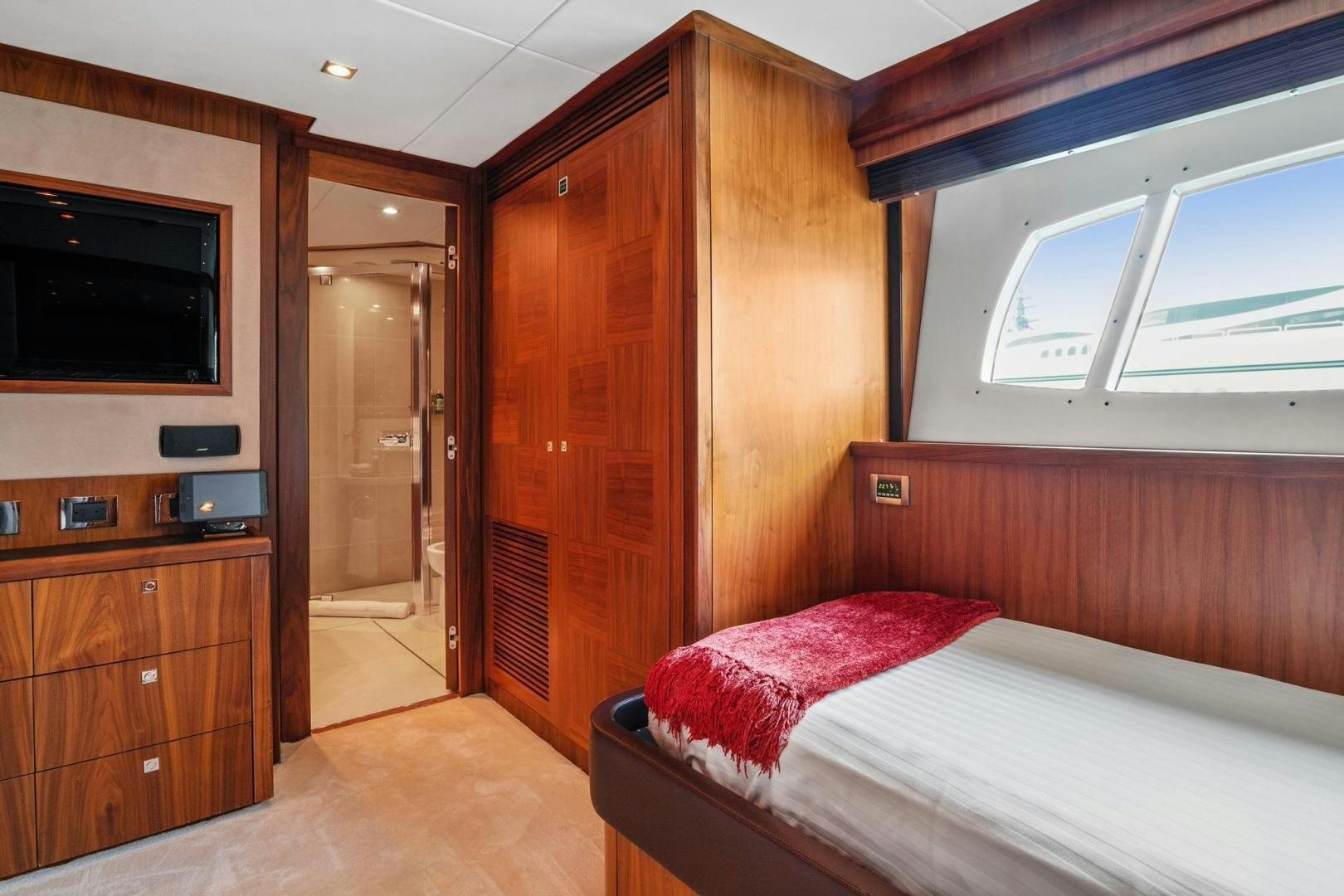 a room with a bed and a television aboard ACACIA Yacht for Sale