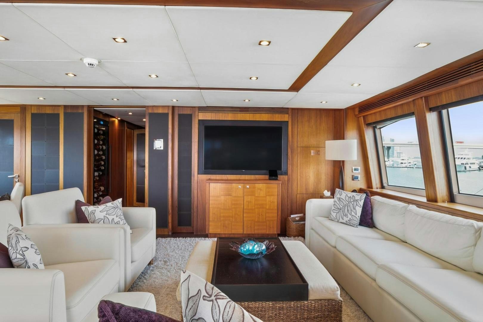 a living room with a tv and couches aboard ACACIA Yacht for Sale