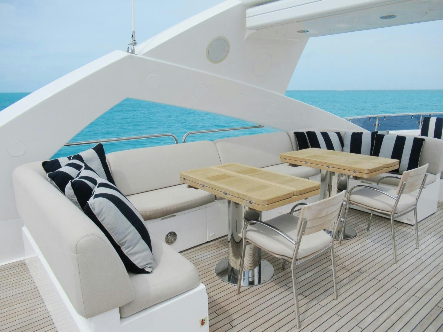 a boat with a table and chairs aboard ACACIA Yacht for Sale