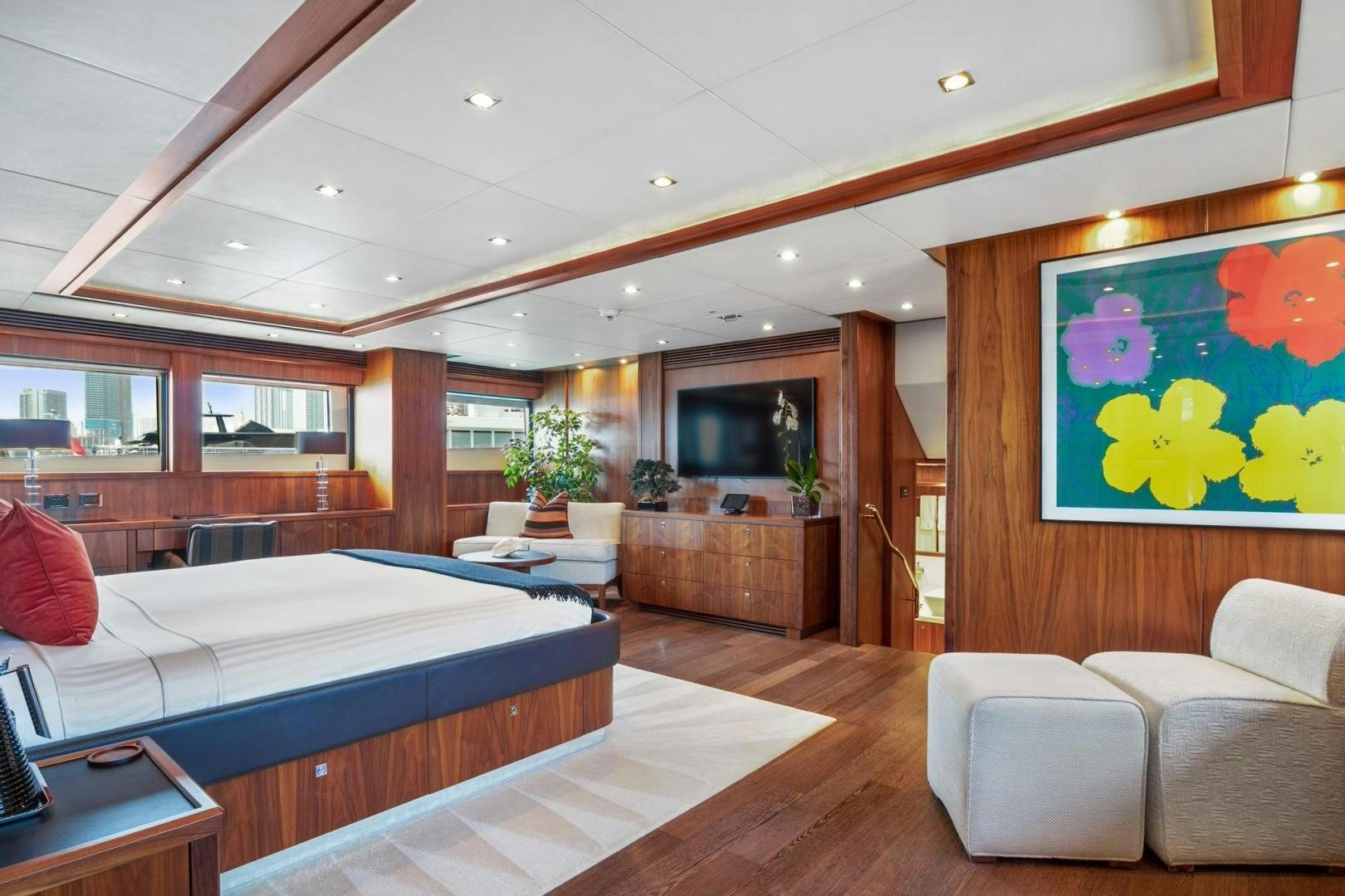 a bedroom with a bed and a tv aboard ACACIA Yacht for Sale