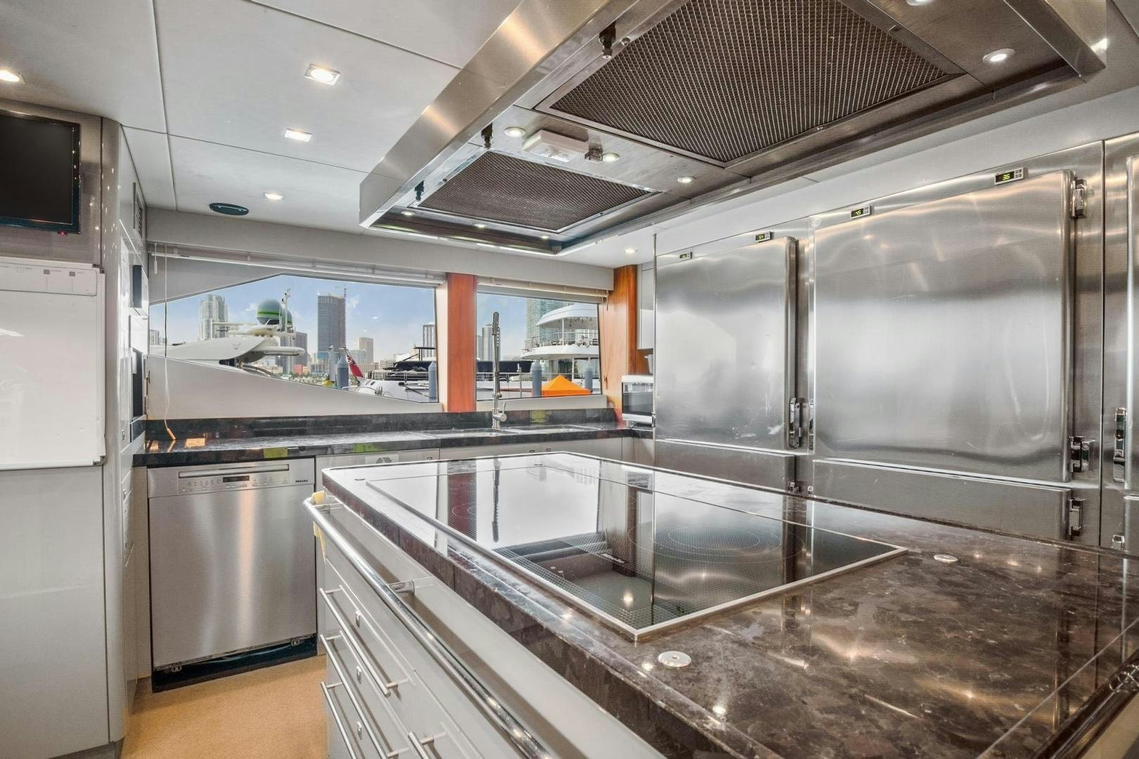 a large kitchen with stainless steel appliances aboard ACACIA Yacht for Sale