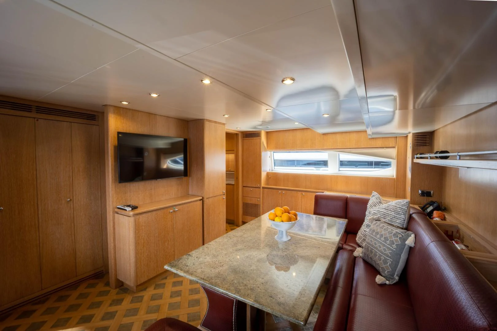 a living room with a table and couches aboard NYHAVEN Yacht for Sale