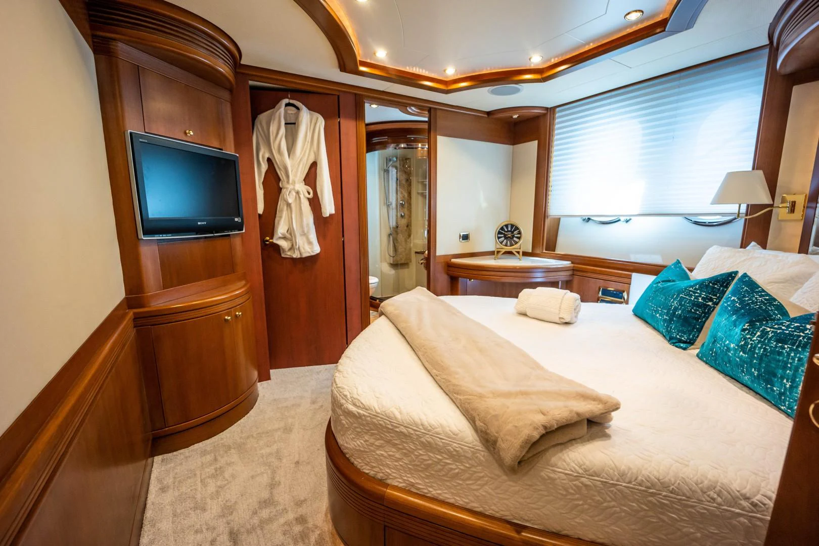 a hotel room with a bed and television aboard NYHAVEN Yacht for Sale