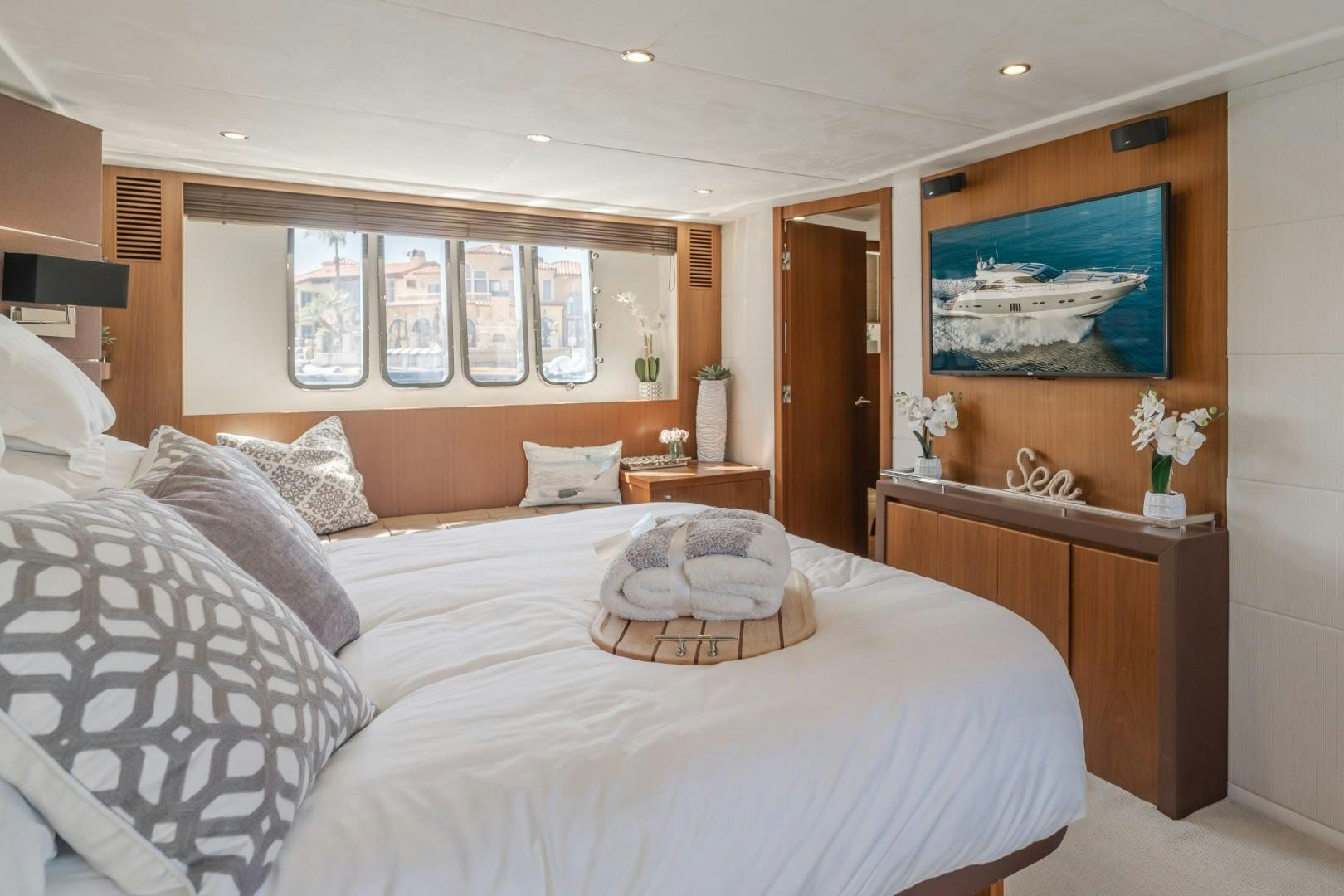 a bed with white sheets and pillows aboard KOINONIA Yacht for Sale