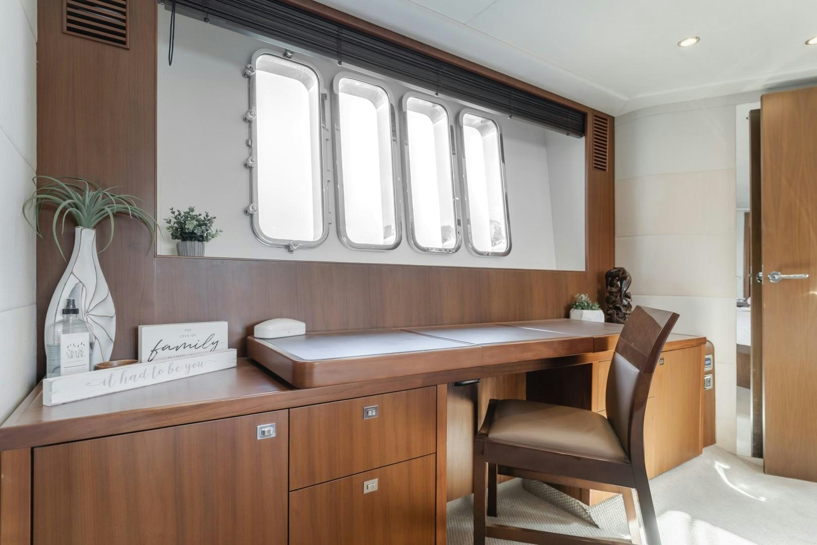 a room with a desk and chairs aboard KOINONIA Yacht for Sale