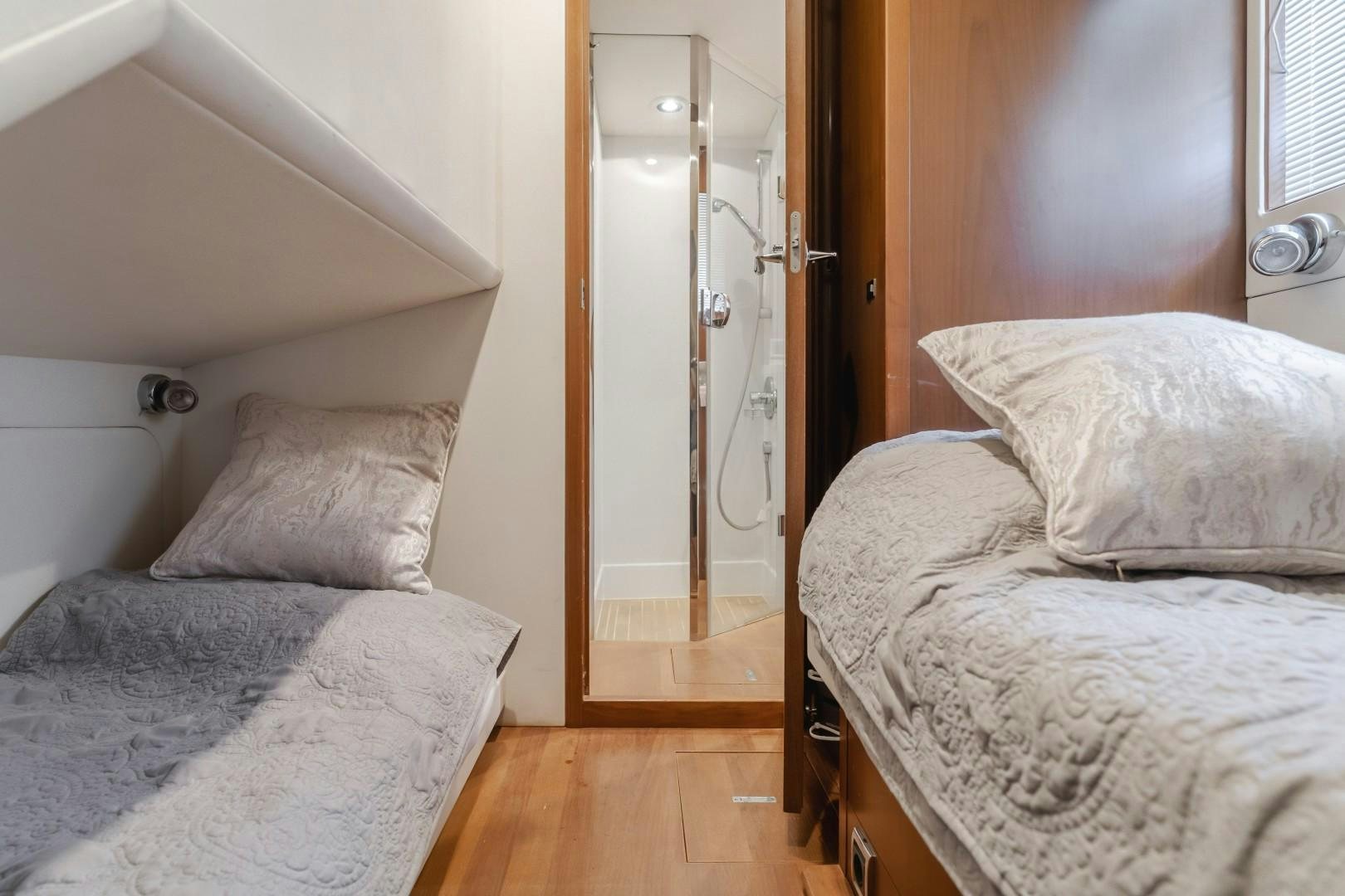 a bedroom with two beds aboard KOINONIA Yacht for Sale
