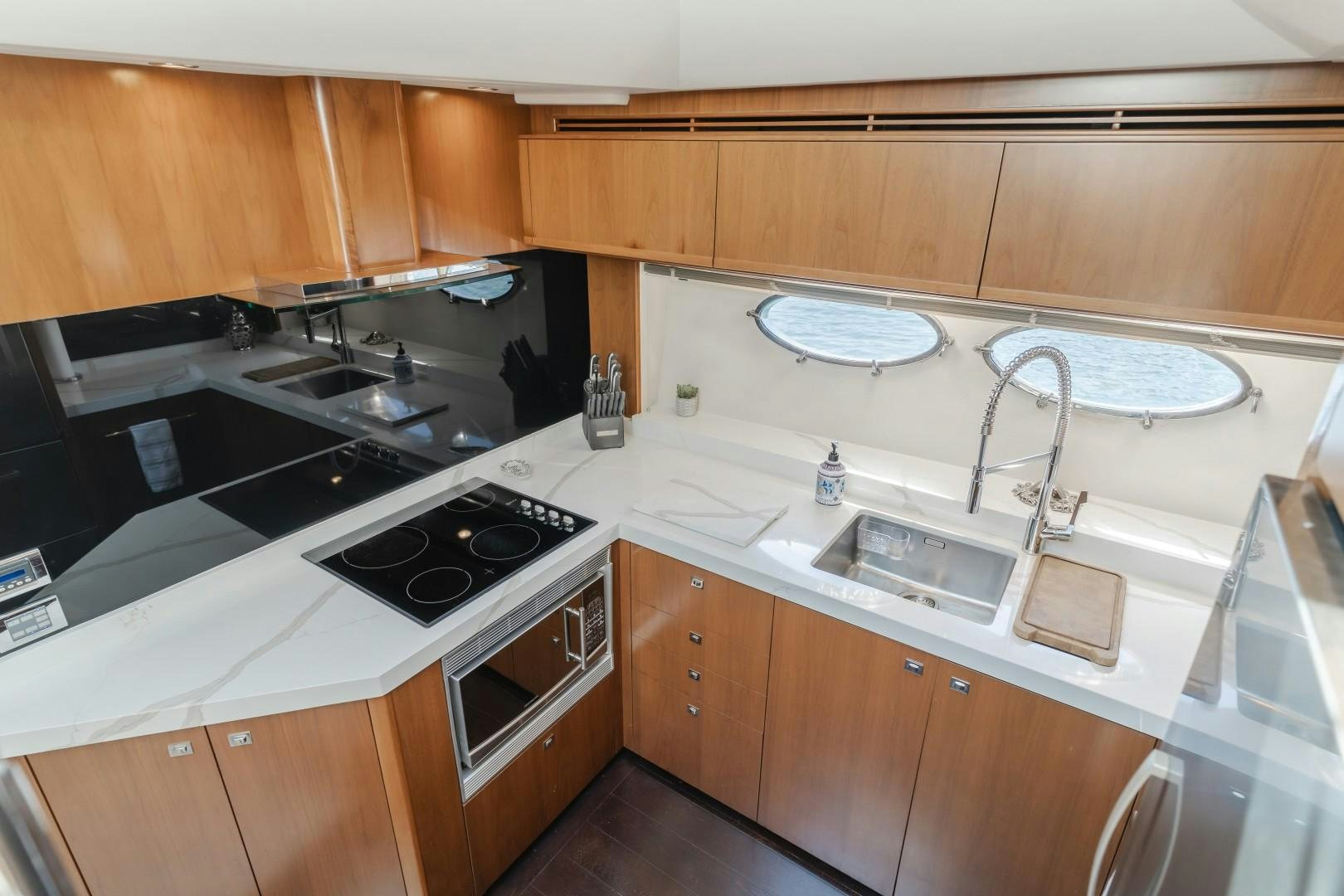 a kitchen with wooden cabinets aboard KOINONIA Yacht for Sale