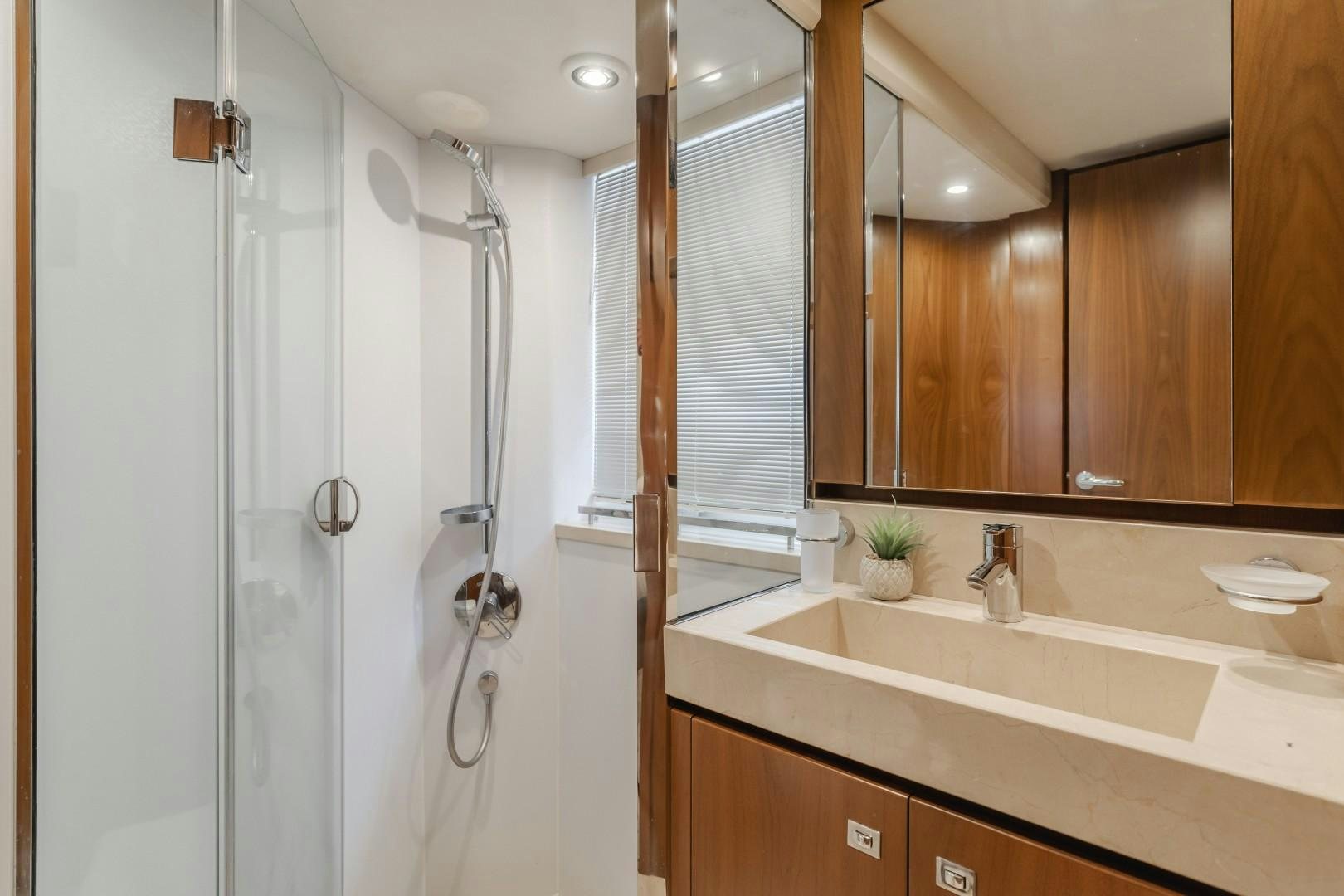 a bathroom with a shower unit and sink aboard KOINONIA Yacht for Sale