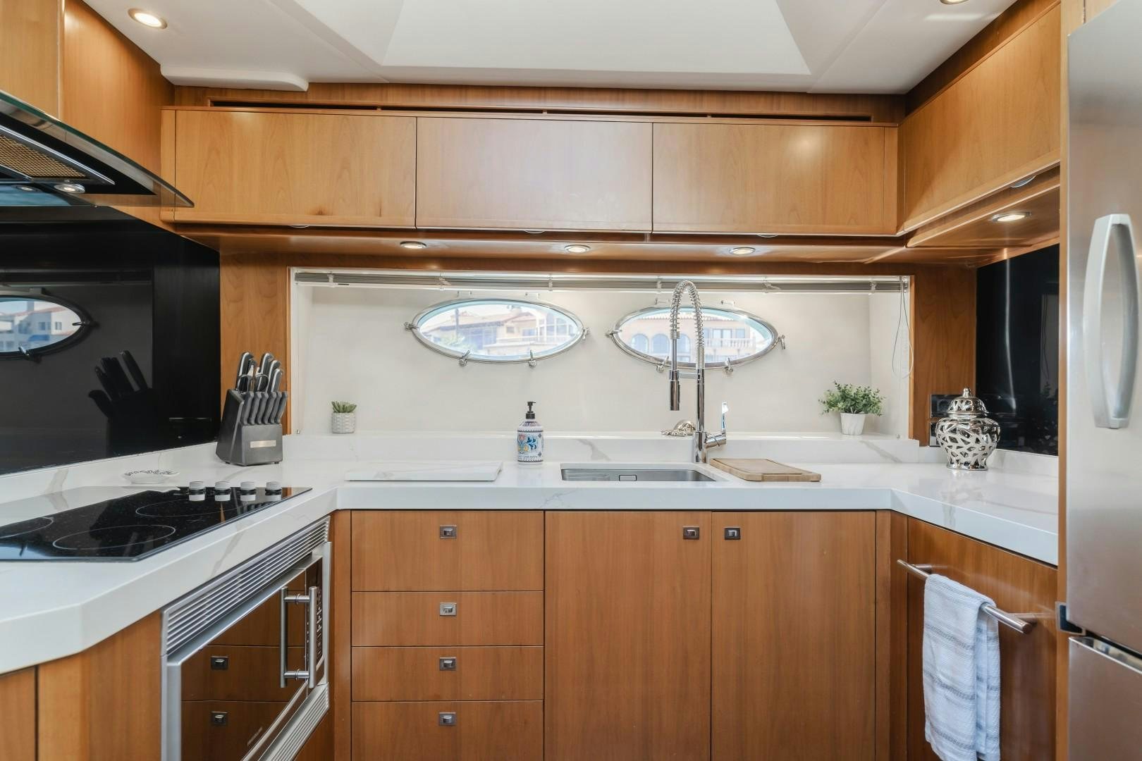 a kitchen with a large white tile wall aboard KOINONIA Yacht for Sale