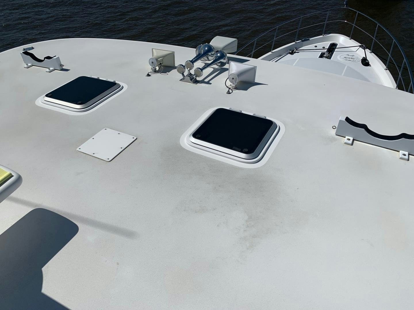 a laptop and a cell phone on a table aboard LADY GIGI Yacht for Sale