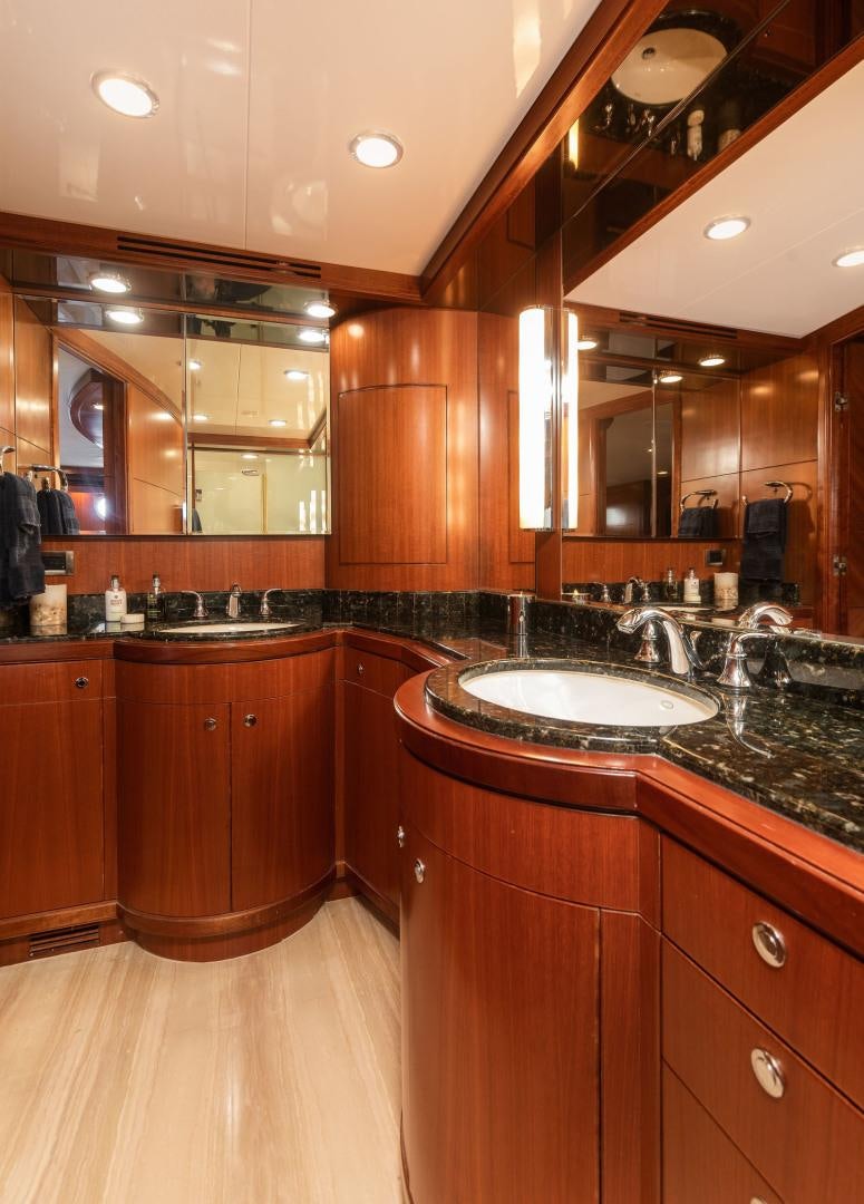 a kitchen with wooden cabinets aboard LADY GIGI Yacht for Sale
