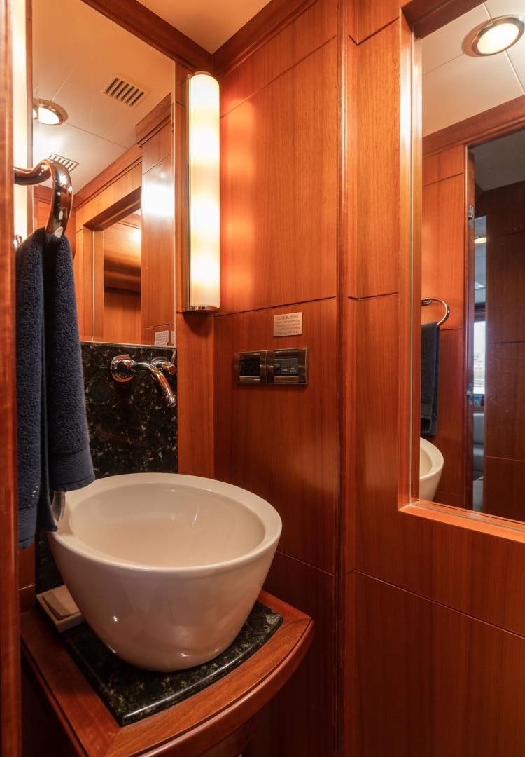 a bathroom with a sink and a mirror aboard LADY GIGI Yacht for Sale