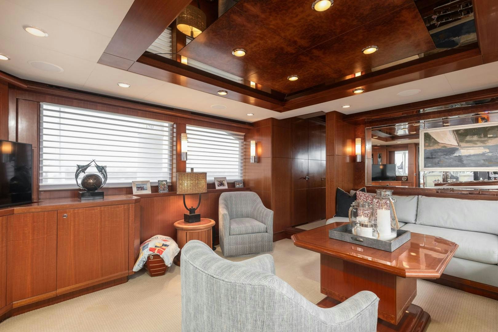 a living room with a wood table aboard LADY GIGI Yacht for Sale