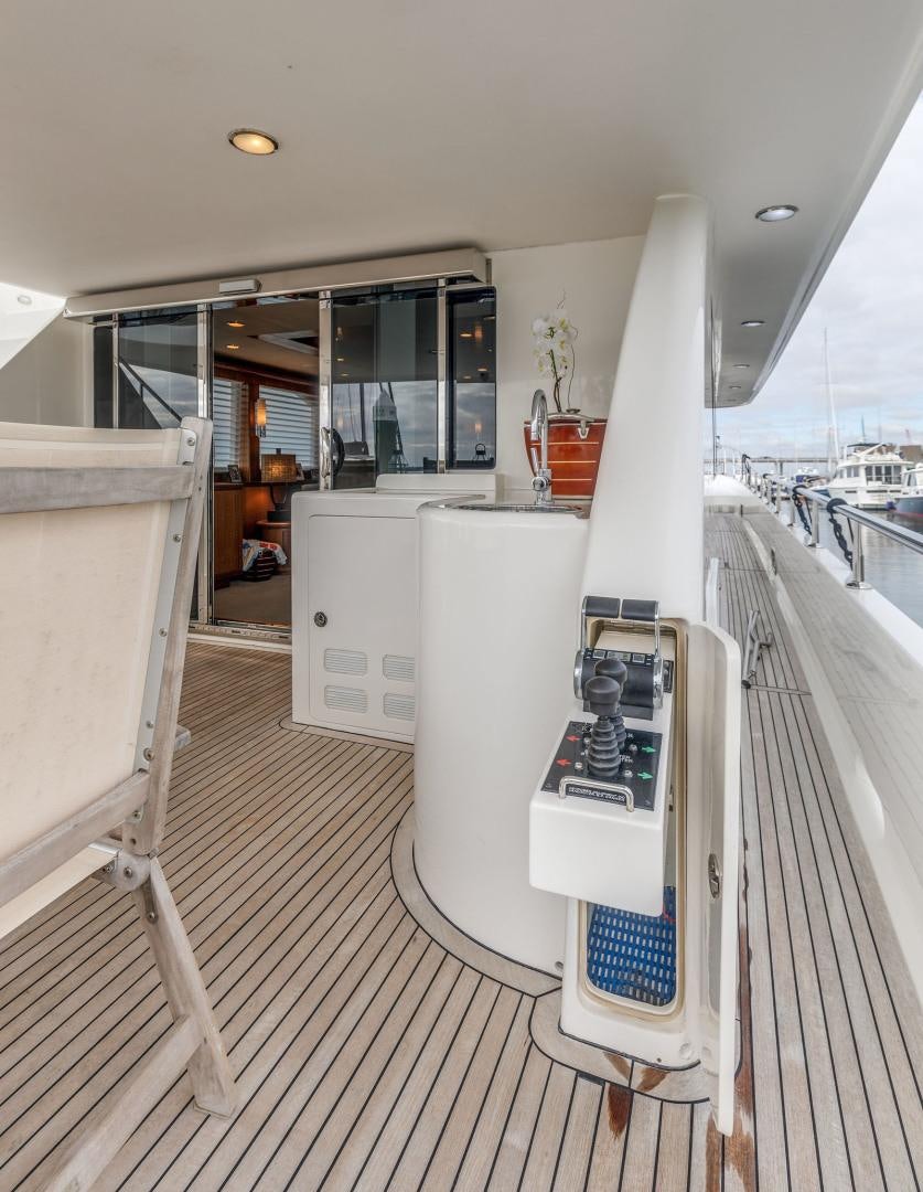 a white boat on a deck aboard LADY GIGI Yacht for Sale