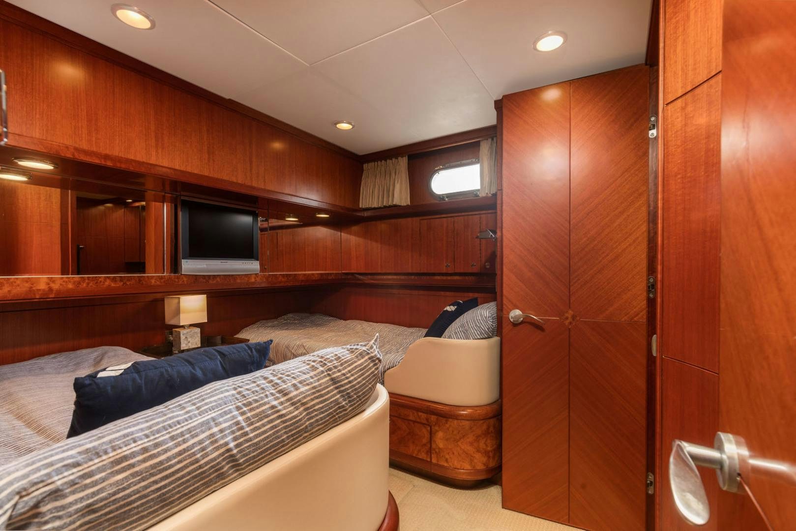 a room with a bed and a tv aboard LADY GIGI Yacht for Sale