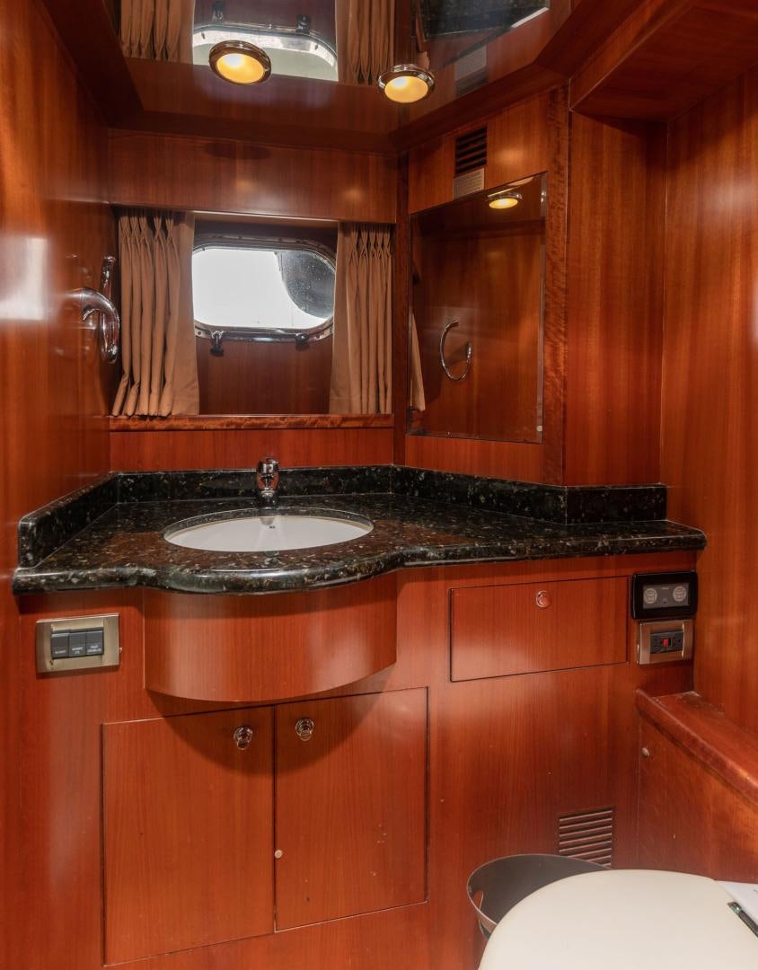 a bathroom with a sink and a mirror aboard LADY GIGI Yacht for Sale