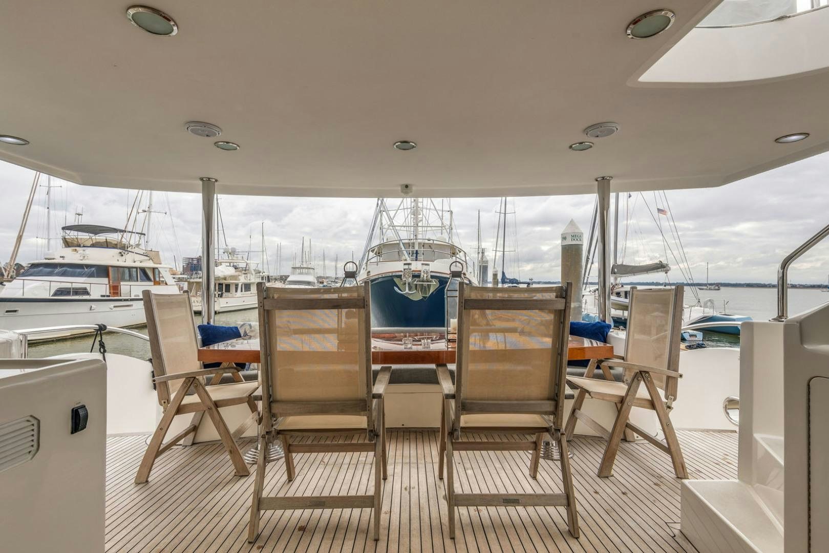 a boat dock with chairs aboard LADY GIGI Yacht for Sale