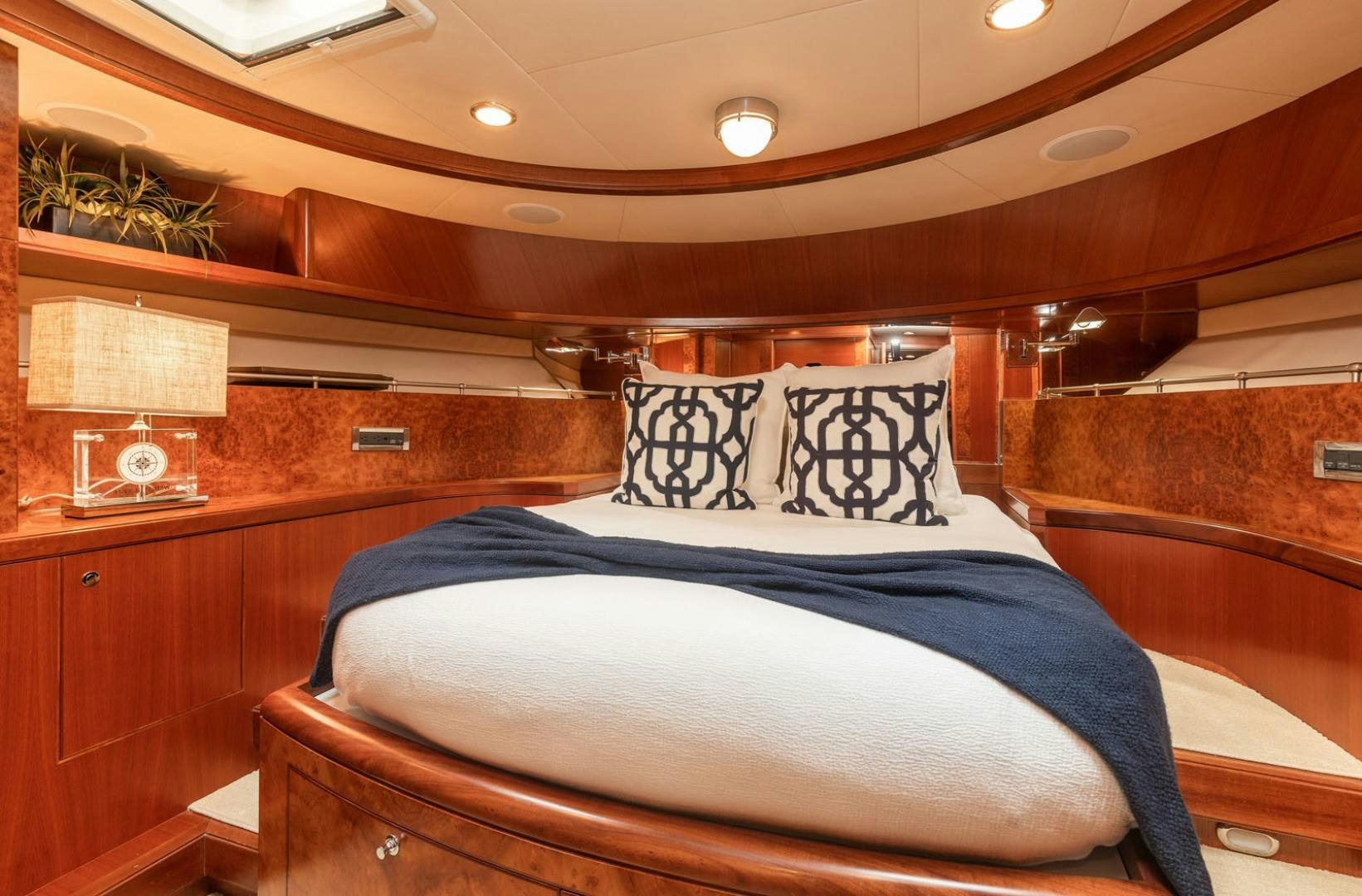 a bed with a blue blanket aboard LADY GIGI Yacht for Sale