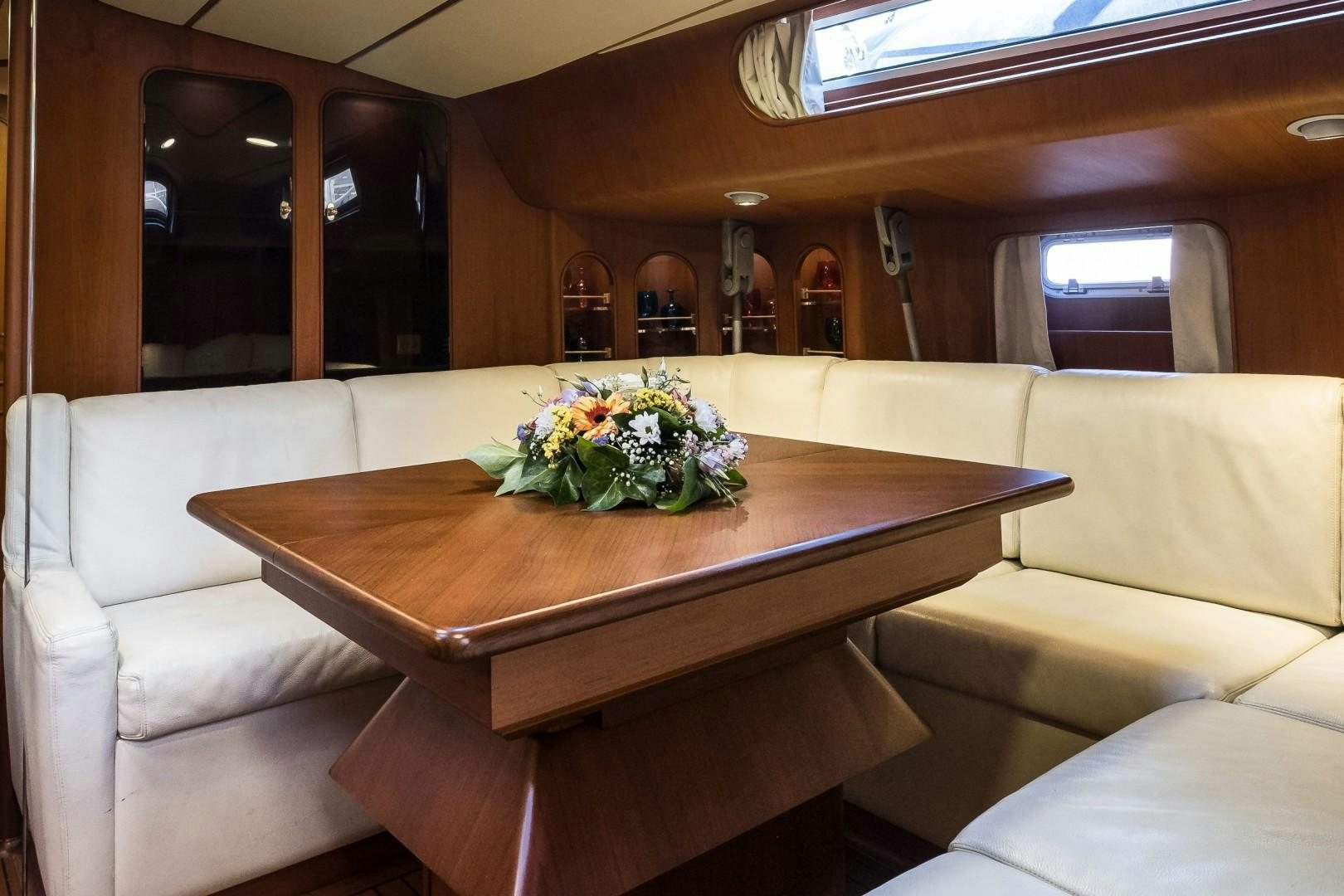 a table with flowers on it aboard ARQUIMEDES Yacht for Sale