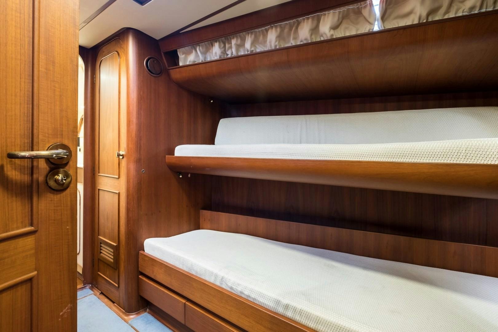 a room with a bed and a door aboard ARQUIMEDES Yacht for Sale