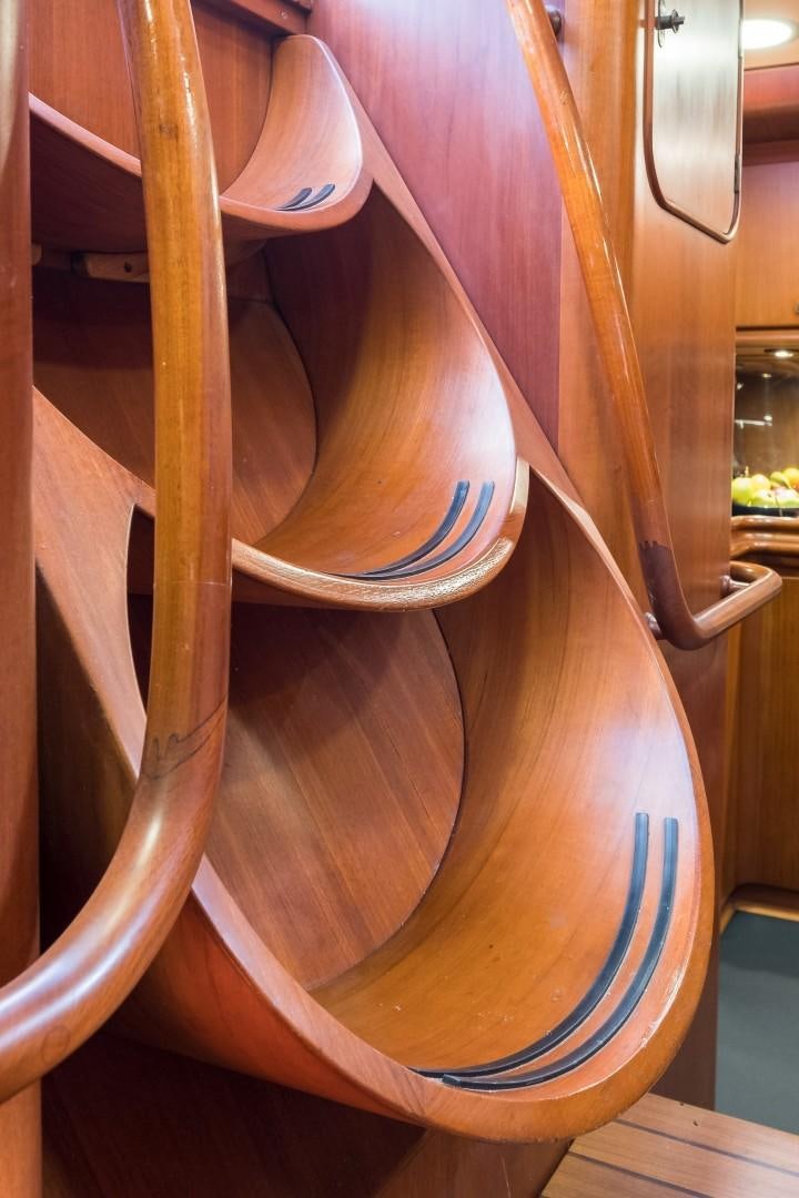 a wooden chair with a blue seat aboard ARQUIMEDES Yacht for Sale