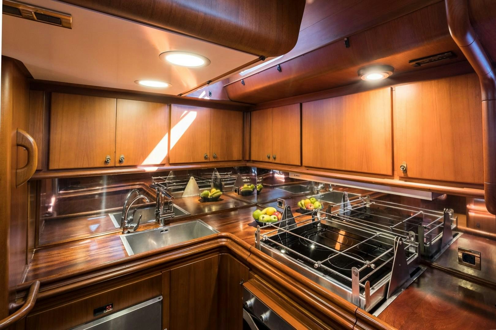 a kitchen with wooden cabinets aboard ARQUIMEDES Yacht for Sale