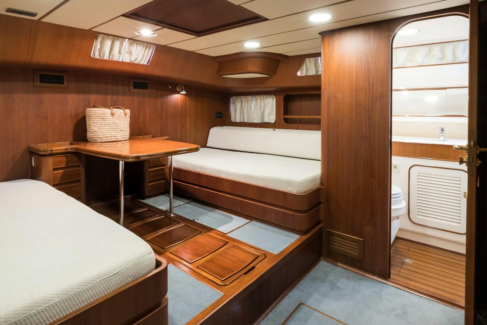 a room with a bed and a table aboard ARQUIMEDES Yacht for Sale
