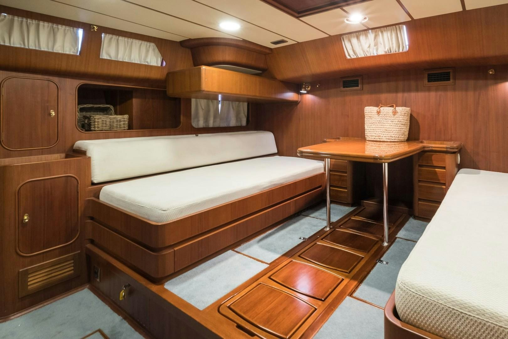 a room with a bed and a table aboard ARQUIMEDES Yacht for Sale