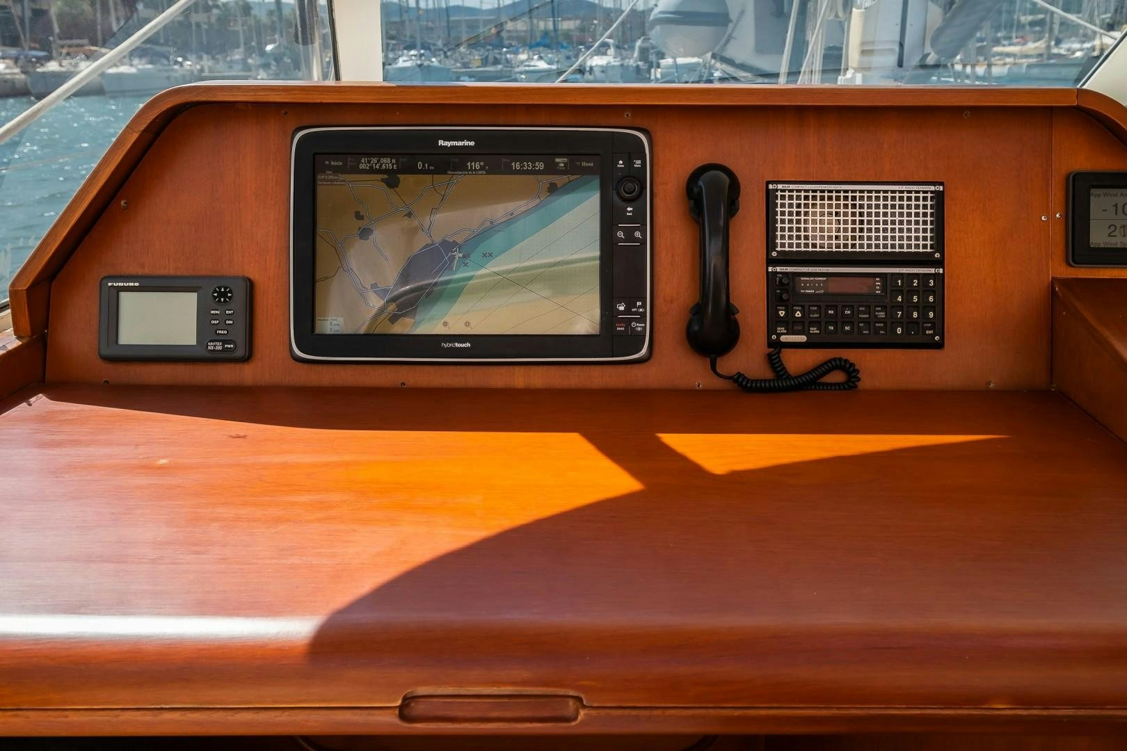 a black electronic device on a wooden surface aboard ARQUIMEDES Yacht for Sale