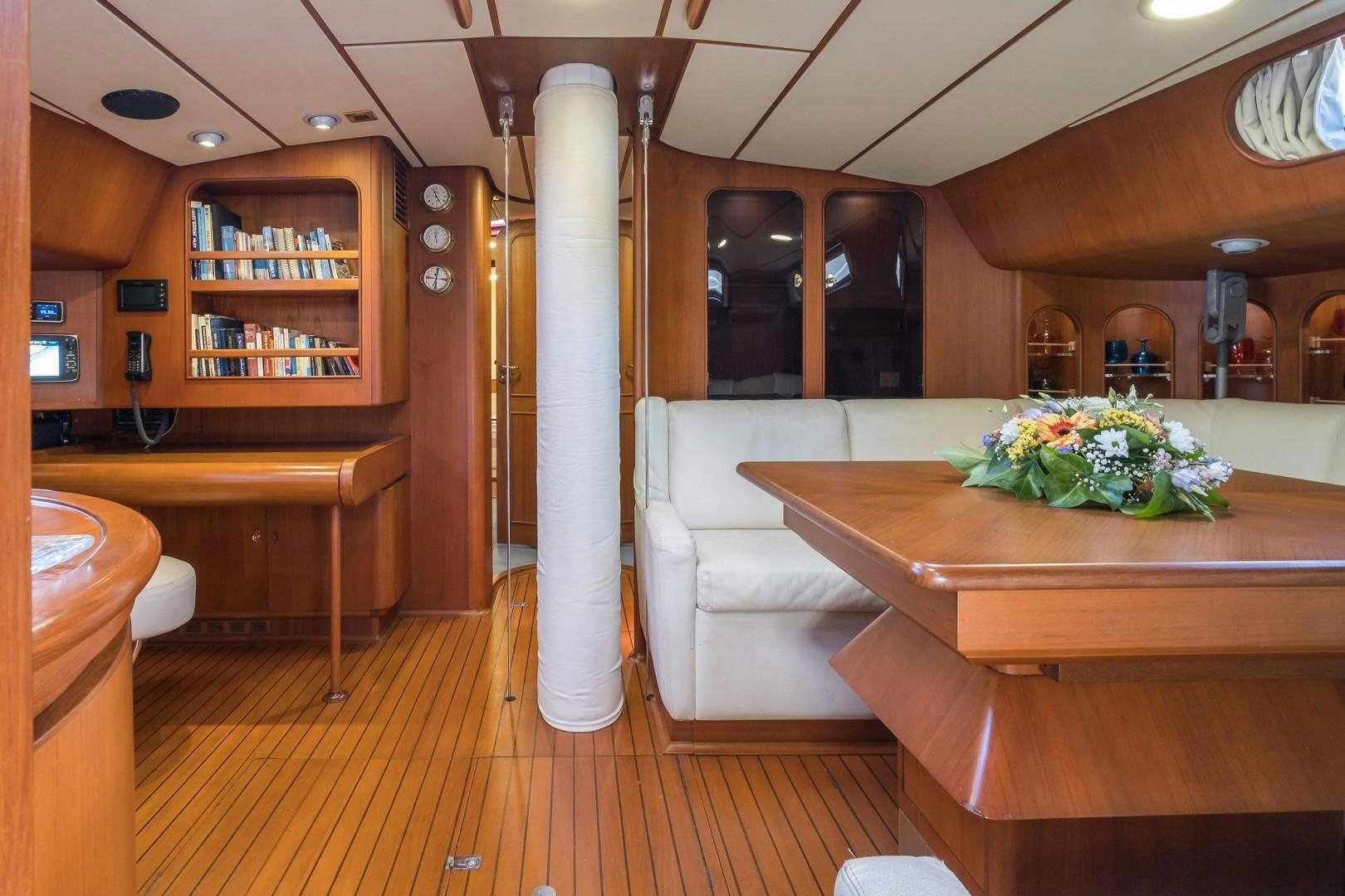 a room with a table and couch aboard ARQUIMEDES Yacht for Sale