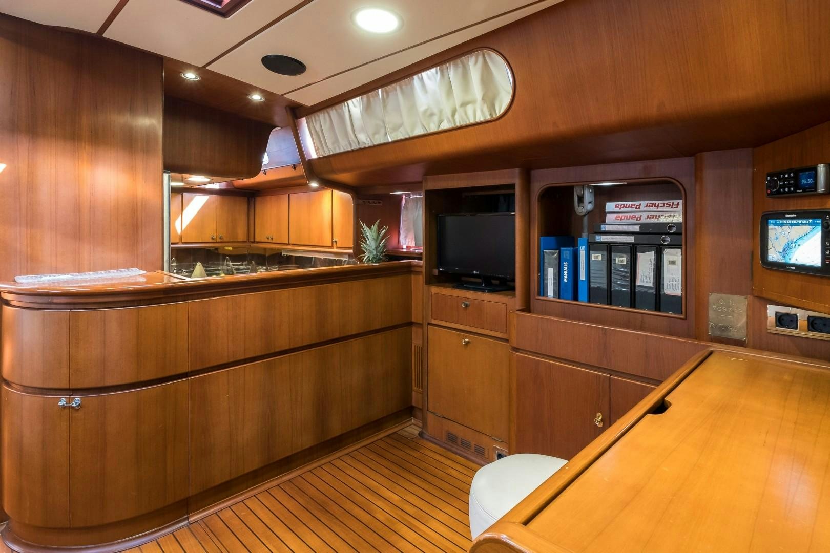 a kitchen with wooden cabinets aboard ARQUIMEDES Yacht for Sale