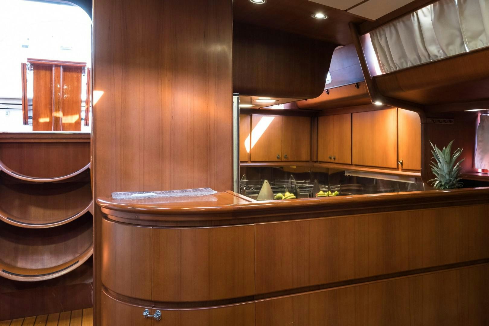 a kitchen with wooden cabinets aboard ARQUIMEDES Yacht for Sale