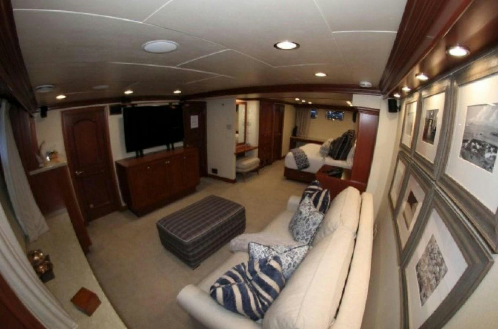 a living room with a couch and a television aboard HURACAN Yacht for Sale
