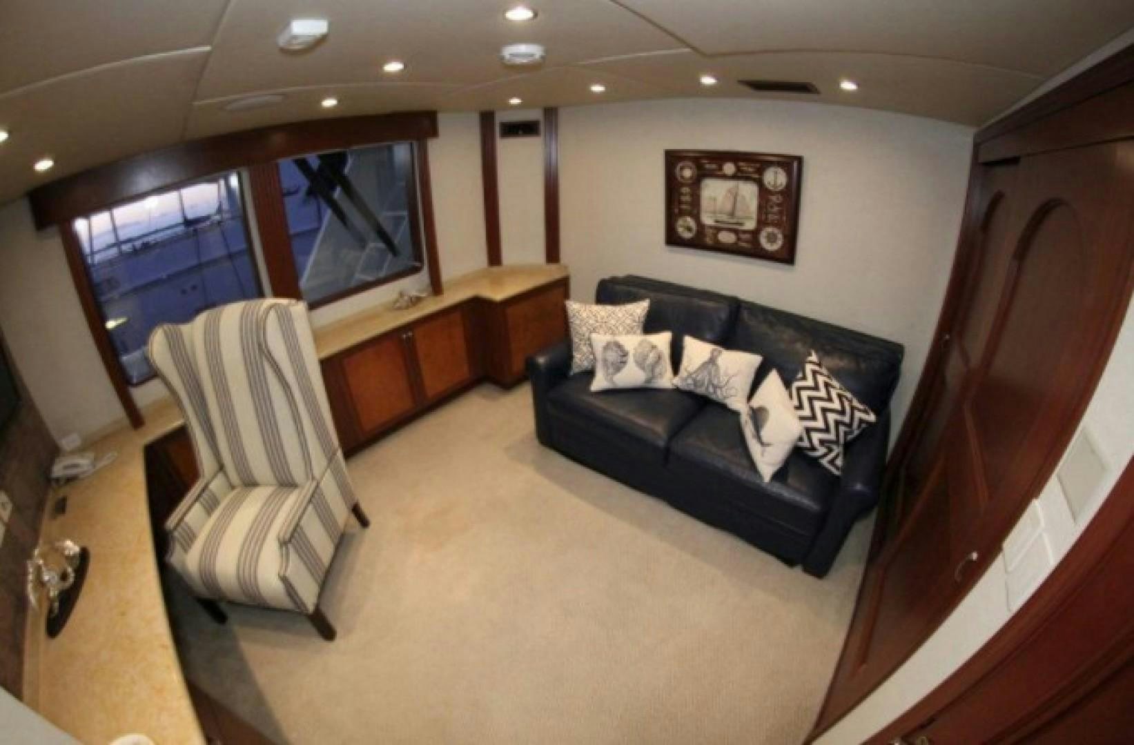 a living room with a leather couch aboard HURACAN Yacht for Sale