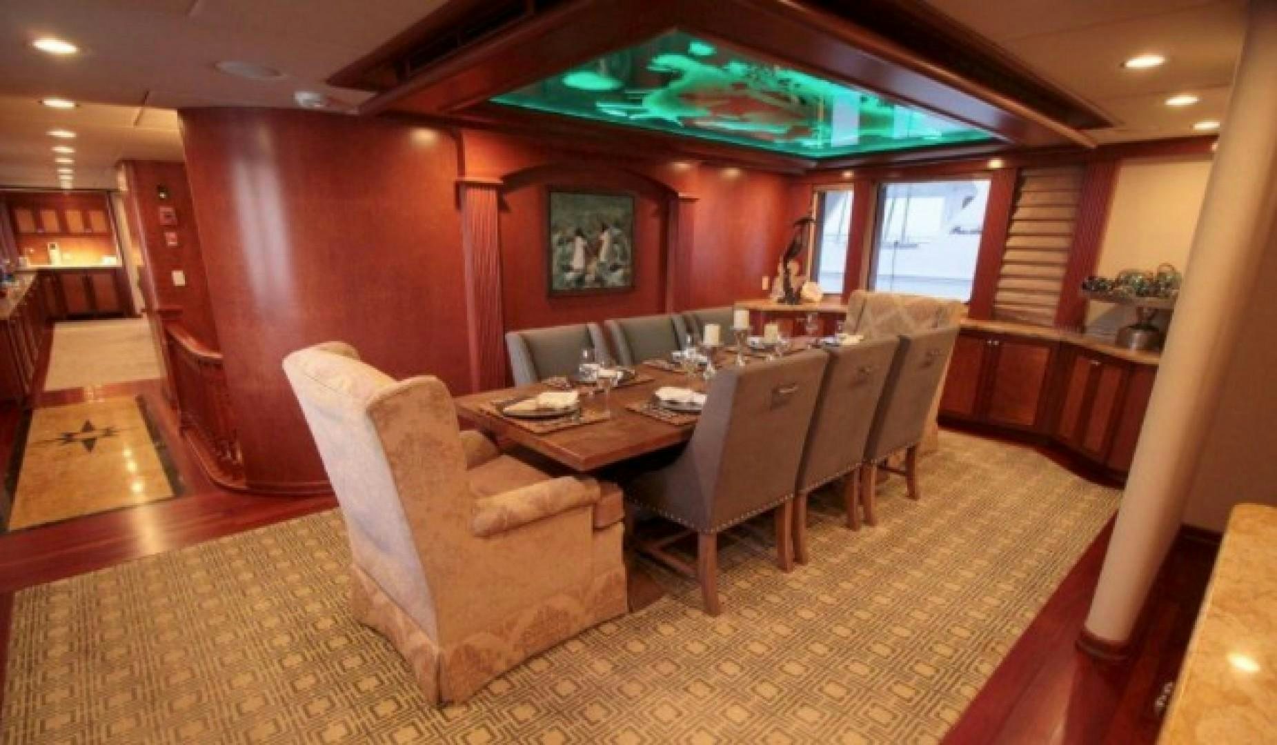 a dining room with a table and chairs aboard HURACAN Yacht for Sale