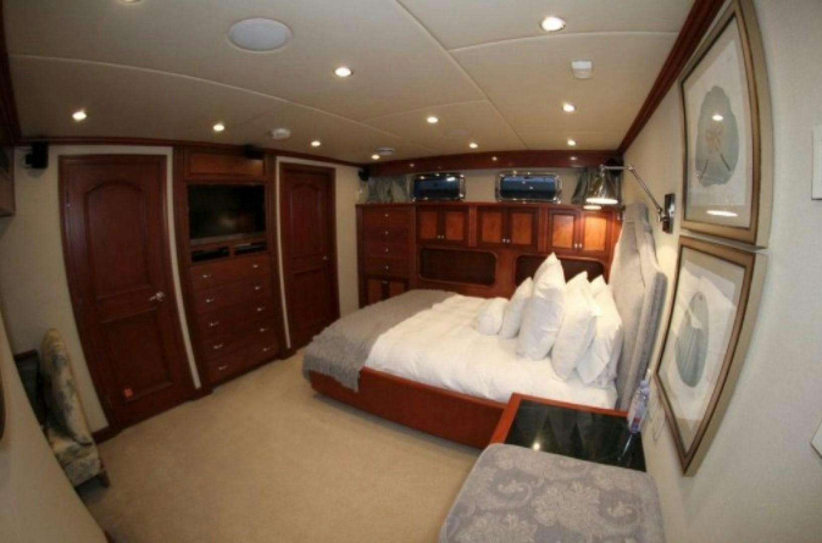 a bedroom with a bed and a mirror aboard HURACAN Yacht for Sale
