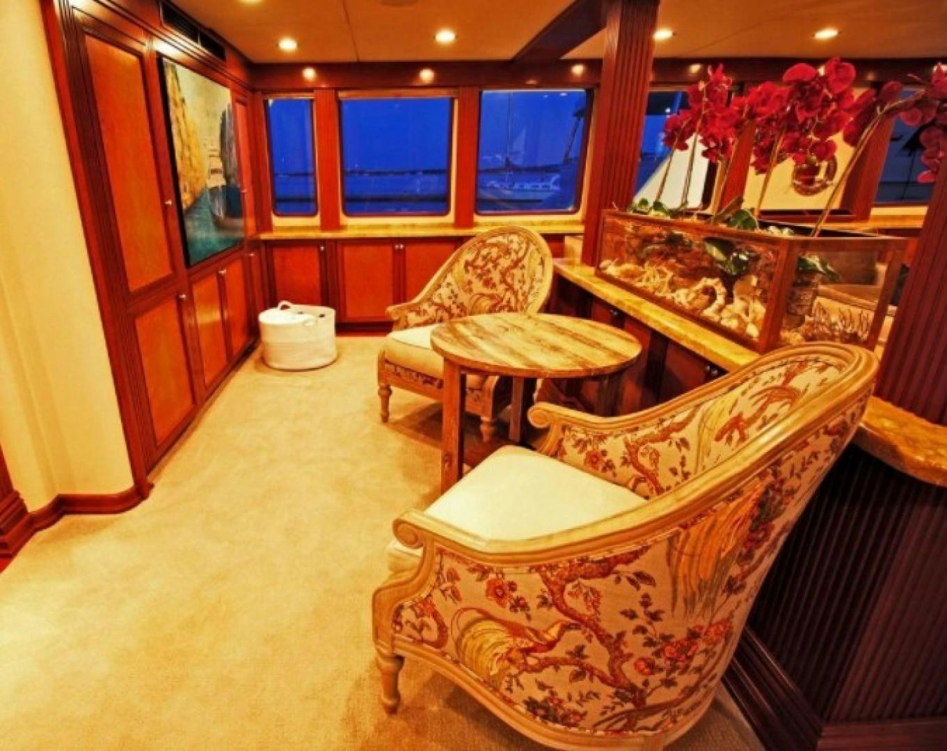 a room with a chair and a table aboard HURACAN Yacht for Sale