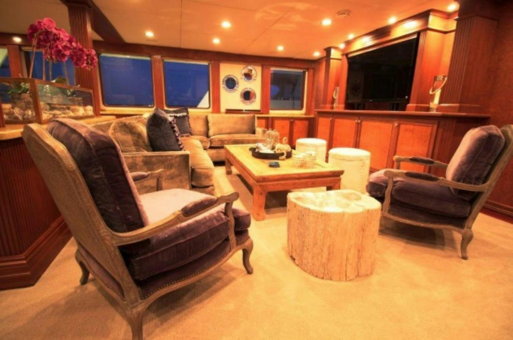 a living room with a couch and a coffee table aboard HURACAN Yacht for Sale