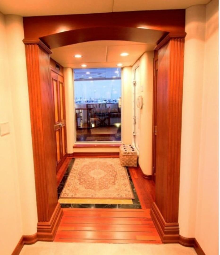 a hallway with a glass door aboard HURACAN Yacht for Sale